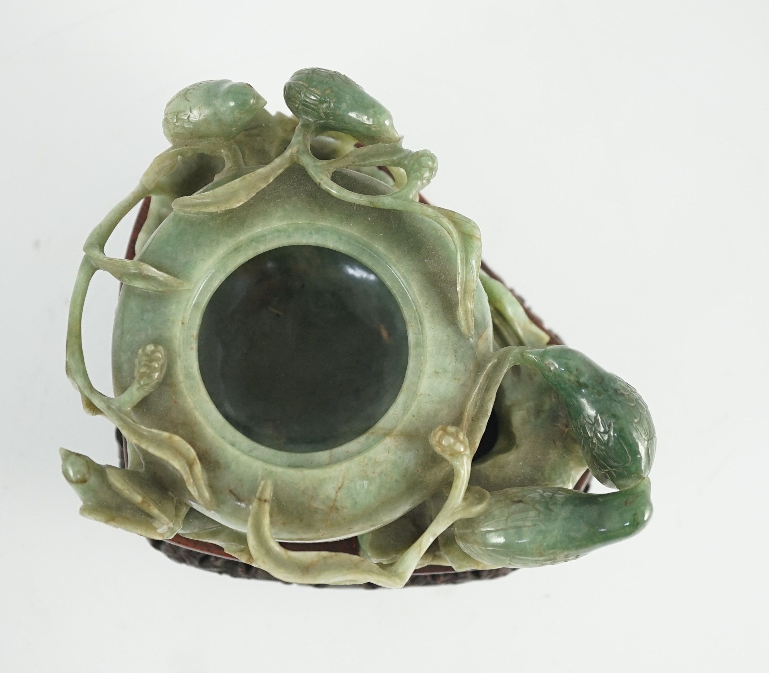 A Chinese jadeite ‘quail and millet’ water pot and stand, late 19th century, original carved and pierced wood stand, total width 15.2cm